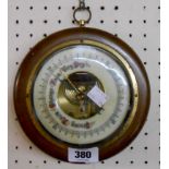 A reproduction polished wood cased sedan style wall barometer with visible aneroid works to dial