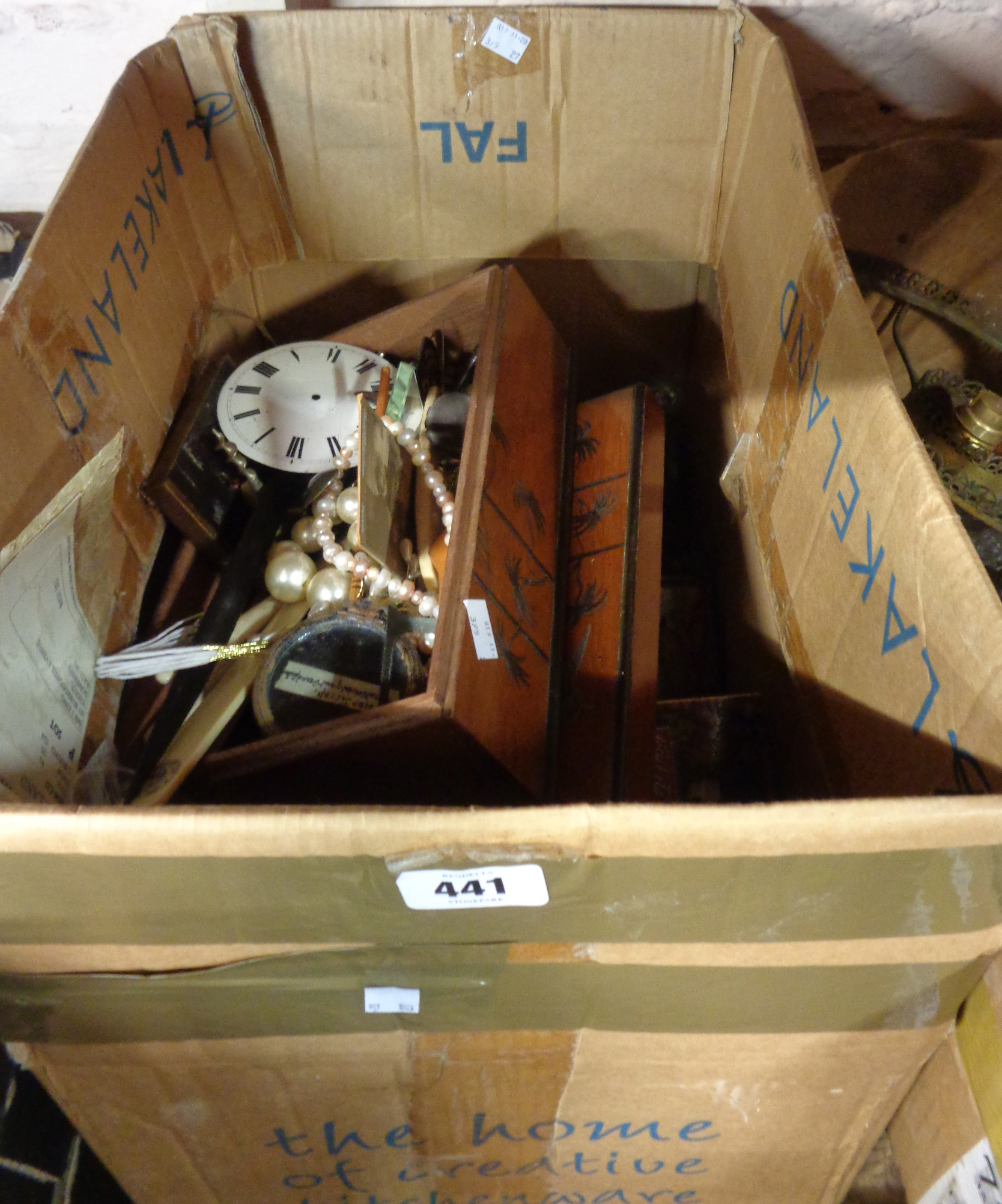 A box containing assorted collectable items including boxes, candlesticks, etc.