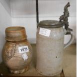 An antique German salt glazed stoneware mug with applied Numbrecht prunt to neck (repair to
