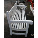A 1.83m painted wood slat back garden bench, set on square supports