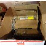 A box containing a quantity of assorted items including weights, brass shelf pins, screws, etc.