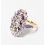 A 1920's style marked 18ct/PLAT bi-metal ring with three open set central diamonds within a