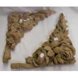 A pair of old wooden spandrels with roses, foliage, and swags