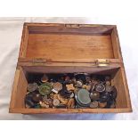 A box containing a collection of vintage buttons