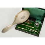 A CASED GEORGE V MANICURE SET, comprising silver mounted buffer, nail file, knife and covered