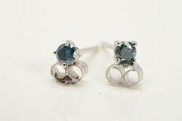 A PAIR OF 18CT WHITE GOLD TREATED BLUE DIAMOND STUD EARRINGS, each designed as a brilliant cut