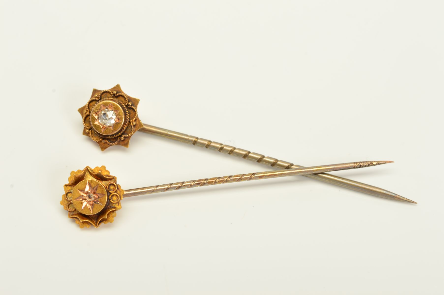TWO LATE VICTORIAN 15CT GOLD DIAMOND STICKPINS, the first designed as an old European cut diamond in