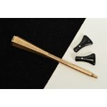 A 9CT GOLD CIGARETTE HOLDER, of hexagonal design with engine turned detail, with two detachable