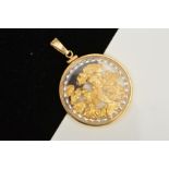 A MODERN CIRCULAR GLASS LOCKET STYLE PENDANT, holding gold coloured nuggets, (please note nuggets