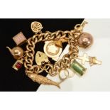 A 9CT GOLD CHARM BRACELET, the curb link bracelet suspending twelve charms, including a Masonic