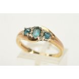 A 9CT GOLD GEM DRESS RING, of slight cross over design, with three graduated blue gems assessed as