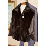 A MINK AND LEATHER JACKET, the dark brown mink fur body with leather tapered sleeves and epaulettes,