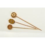 THREE LATE VICTORIAN 15CT GOLD DIAMOND STICKPINS, all with central star set diamonds, one in a