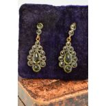 A PAIR OF PERIDOT DROP EARRINGS, designed as a central pear-shape peridot within a graduated