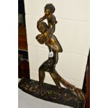 AN ART DECO STYLE BRONZED FIGURE GROUP, depicting women carrying child on her shoulders with