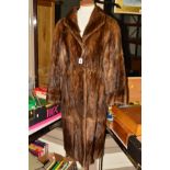 A FUR COAT, beleived to be nutria fur, with lapel collar, two hook fastenings, floral lining,