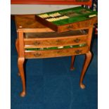 A 1930'S WALNUT THREE DRAWER CANTEEN TABLE ON CABRIOLE LEGS, the three baize lined drawers fitted