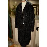 A PERSIAN LAMB FUR COAT, with three hook fastenings, wide cuffs, label for A.Dudkin, believed to