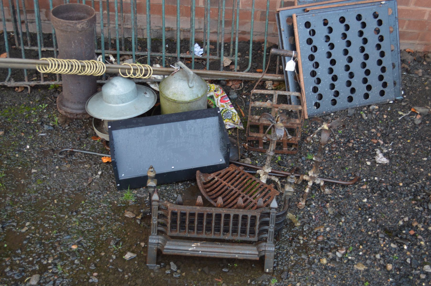 A COLLECTION OF METALWARE to include two galvanised bird feeders, two cast iron fire grates, a