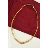 A NECKLACE, designed as tapered pierced Greek-key pattern panels to the plain panelled back chain,