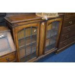 AN EARLY 20TH CENTURY OAK LEAD GLAZED DOUBLE DOOR BOOKCASE, width 122cm x depth 34cm x height