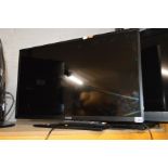 A LINSAR 32'' LED TV (one remote) together with a glass TV stand (2)