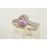 A MODERN 18CT WHITE GOLD PINK SAPPHIRE AND DIAMOND OVAL CLUSTER RING, pink sapphire measuring