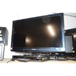 A PANASONIC LCD 32'' TV together with a Panasonic DVD player (two remotes) together with a glass