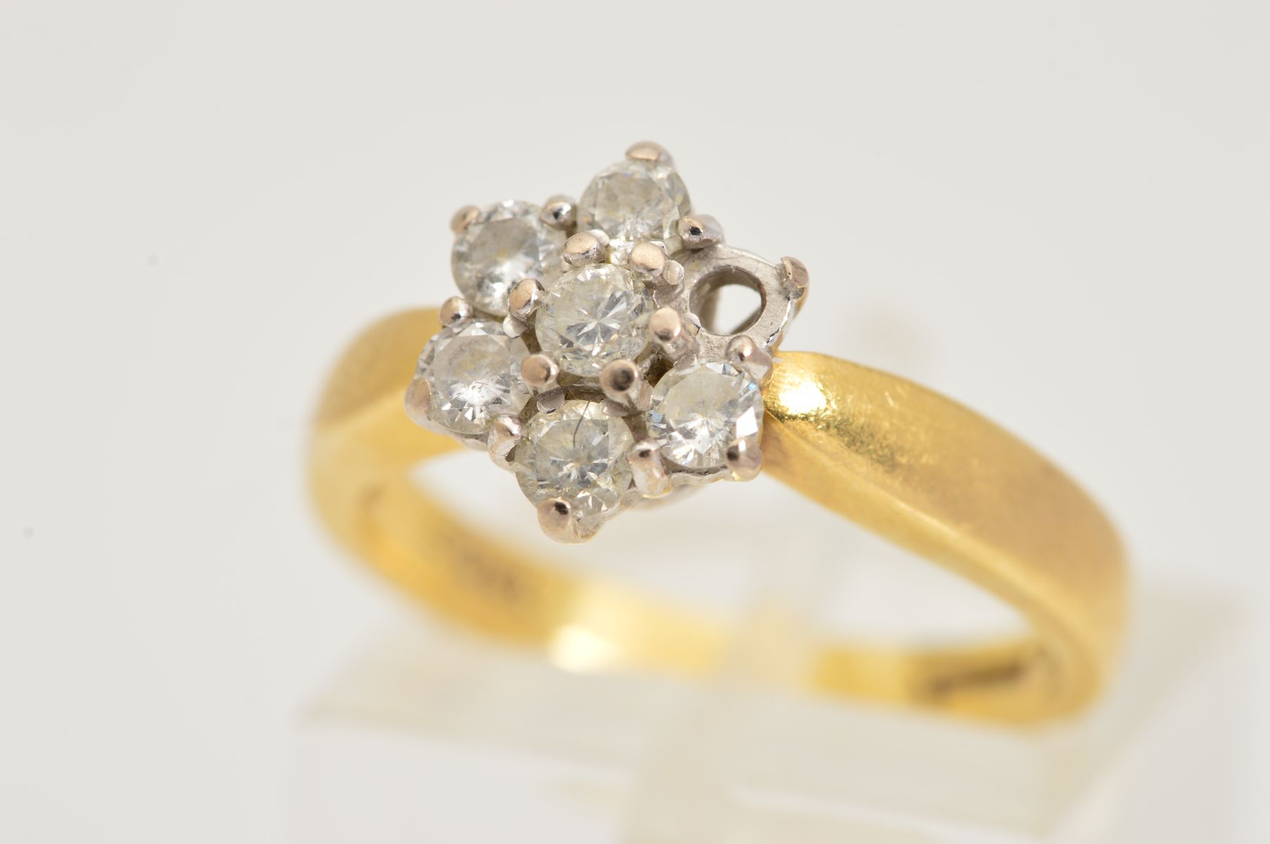 AN 18CT GOLD DIAMOND CLUSTER RING, designed as a two tier cluster of seven claw set brilliant cut
