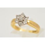 AN 18CT GOLD DIAMOND CLUSTER RING, designed as a two tier cluster of seven claw set brilliant cut