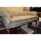 A VICTORIAN WALNUT FLORAL UPHOLSTERED THREE SEATER SETTEE