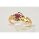 A RUBY AND DIAMOND RING, designed as an oval glass filled ruby in a four claw setting within an