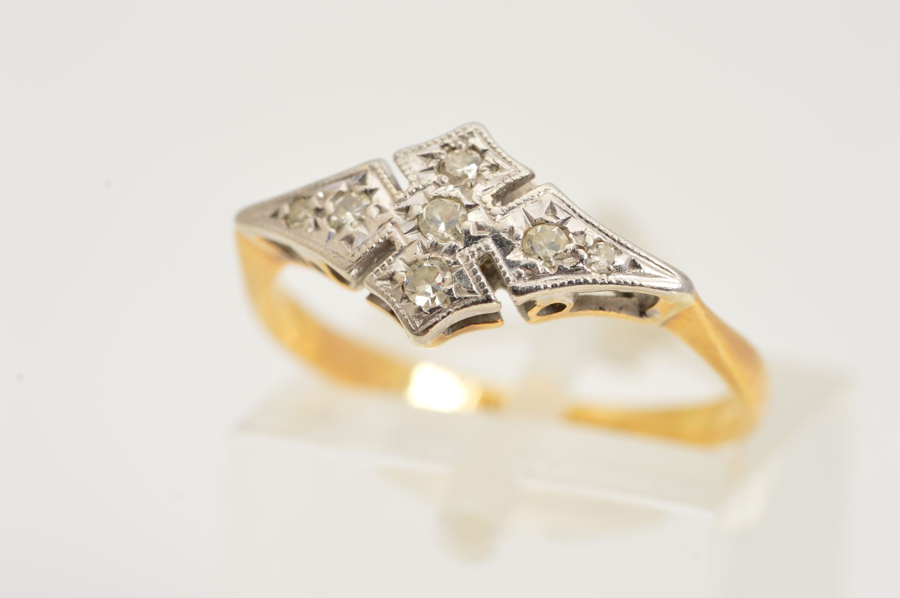 AN EARLY 20TH CENTURY DIAMOND RING, designed as four single cut diamonds in illusion settings to the