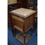 AN EDWARDIAN OAK MARBLE TOPPED POT CUPBOARD with a single drawer