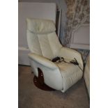 AN ELECTRIC CREAM LEATHER SWIVEL RECLINING ARMCHAIR on a circular wooden base