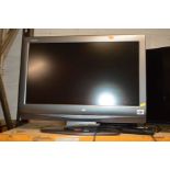 A SHARP 26'' LCD TV (one remote) together with a glass TV stand (2)