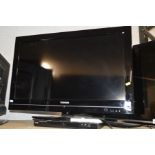 A TOSHIBA 32'' LCD TV together with a Logik DVD player (two remotes) together with a glass TV