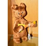 A CLOCKWORK BEAR PLAYING GUITAR, playworn condition but appears complete with key and in working