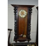 A DISTRESSED VICTORIAN WALNUT VIENNA WALL CLOCK