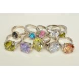 TEN MAINLY CUBIC ZIRCONIA RINGS, to include four claw set with large circular coloured cubic