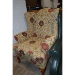 A MULTI YORK FLORAL UPHOLSTERED WINGBACK ARMCHAIR on cabriole legs