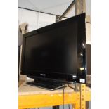 A PANASONIC 32'' LCD TV (no remote) together with a glass TV stand (2)