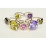 SEVEN CUBIC ZIRCONIA RINGS, two designed as a large circular cubic zirconia in a four claw