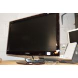 A SAMSUNG 27'' LCD TV (one remote) together with a glass TV stand (2)