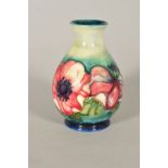 A SMALL MOORCROFT POTTERY VASE, 'Anemone' pattern on blue/green ground, impressed backstamp,