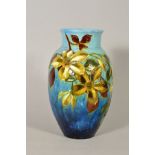 A BURMANTOFTS FAIENCE VASE decorated with foliage and flowers on blue ground, impressed No1079,