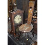 AN EDWARDIAN MAHOGANY SPINNING STOOL together with a wall clock (2)