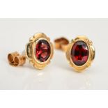 A PAIR OF GARNET STUD EARRINGS, each designed as an oval garnet in a collet setting within an