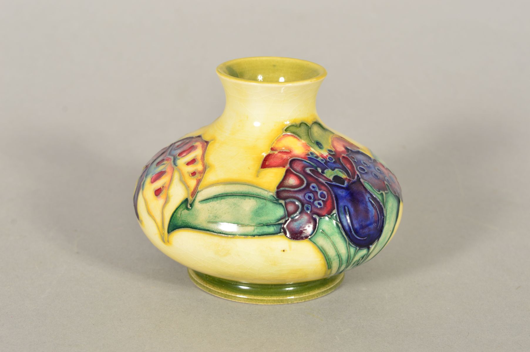 A SMALL MOORCROFT POTTERY SQUAT VASE, 'Orchid' pattern on yellow ground, impressed and painted