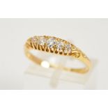 AN EDWARDIAN 18CT GOLD DIAMOND RING, designed as a line of graduated old cut diamonds within claw
